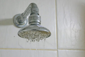 A shower head showing low shower water pressure.